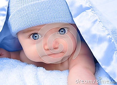 little-boy-baby-laying-under-blue-blanket-thumb16610605.jpg